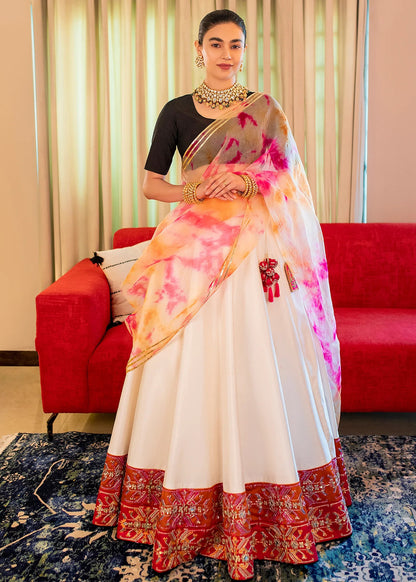 Black and white raw silk Pakistani lehenga choli with mirror, pitta, and sequin embellishments, paired with black choli and tie-dye dupatta – ideal for receptions and formal events.