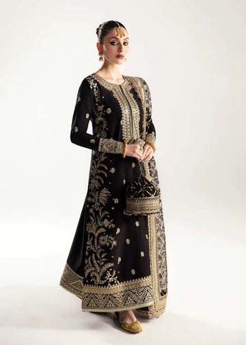 Black raw silk frock with churidar pajama and sequined organza dupatta.