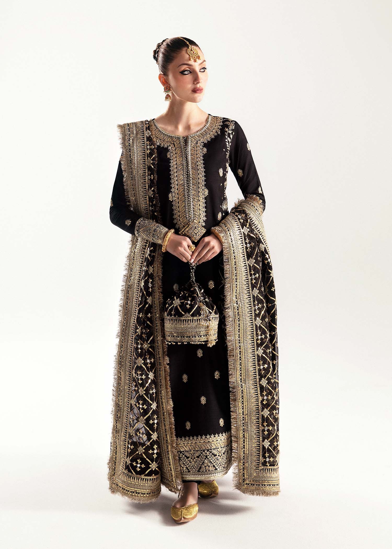Black raw silk frock with churidar pajama and sequined organza dupatta.