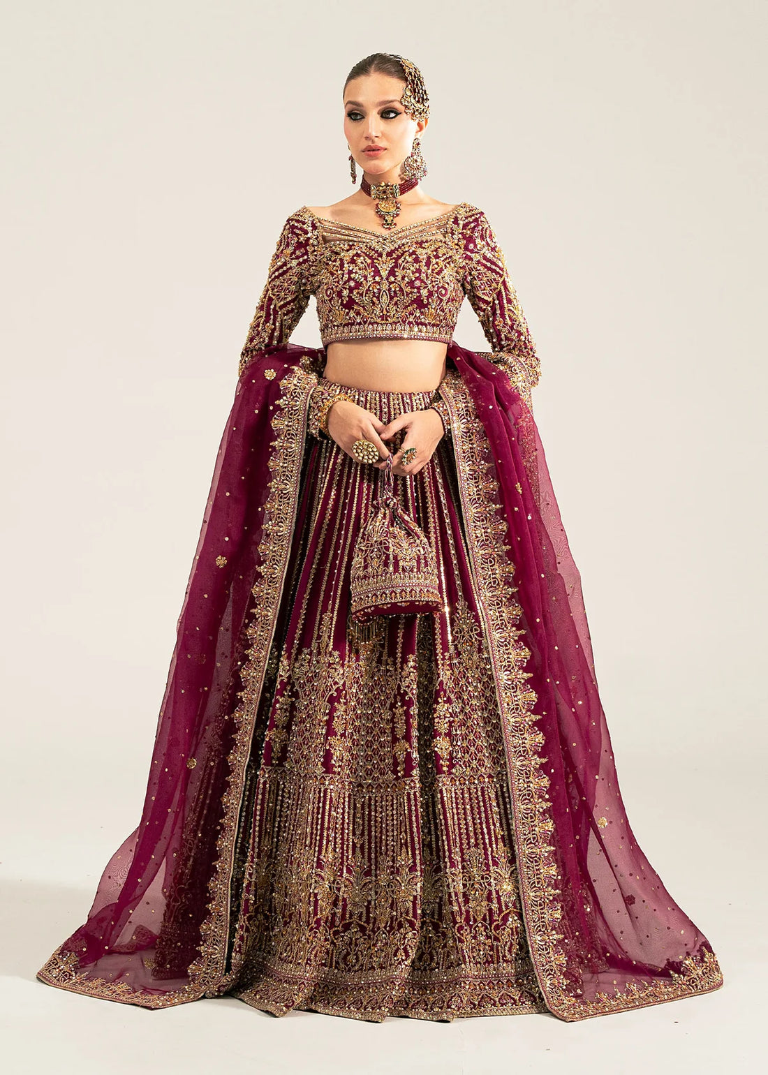 Raina stitched plum lehenga choli set by Kanwal Malik in Korean raw silk, featuring gold and silver hand embellishments with an organza dupatta.