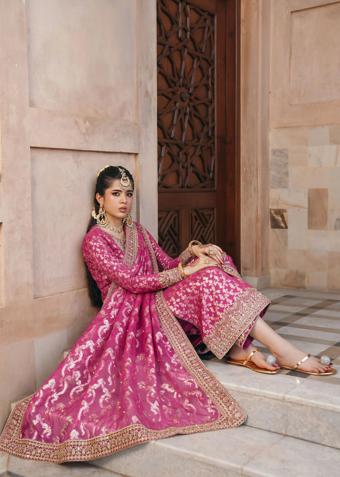 Rano shocking pink badla embroidered suit with hand-embroidered neckline, silk pants with gota lace, and dupatta by Kanwal Malik for dholki and mehndi wear.