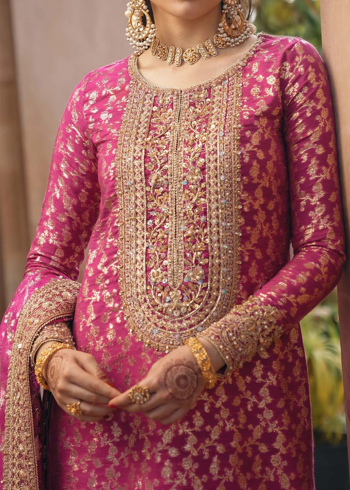 Rano shocking pink badla embroidered suit with hand-embroidered neckline, silk pants with gota lace, and dupatta by Kanwal Malik for dholki and mehndi wear.