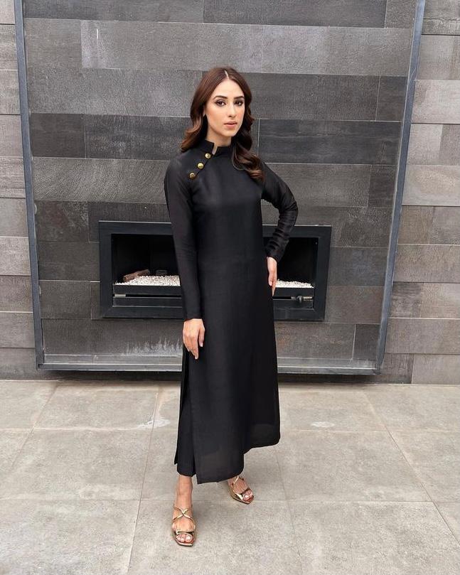 black long shirt dress pakistani A statement black long shirt with fine golden detailing, finished with a bordered dupatta and sleek fused trousers. black tessel silk dress, black formal dress Pakistan, golden handwork dress, luxury black outfit,