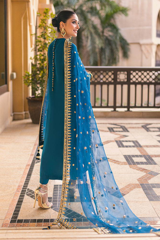 Sapphire blue Pakistani silk dress with back handwork buttons, churidar pants, and a gota embellished dupatta – ideal for weddings and formal events.