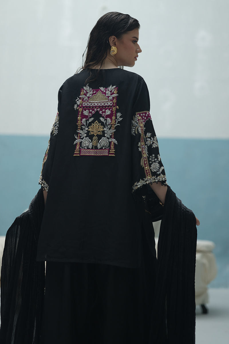 Formal black Pakistani raw silk outfit with embellished kurta, farshi culottes, and crushed dupatta – ideal for weddings and Eid abroad.