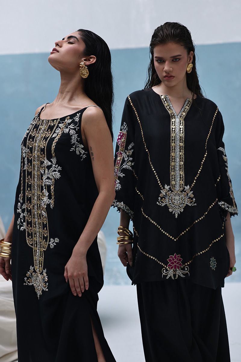 Formal black Pakistani raw silk outfit with embellished kurta, farshi culottes, and crushed dupatta – ideal for weddings and Eid abroad.