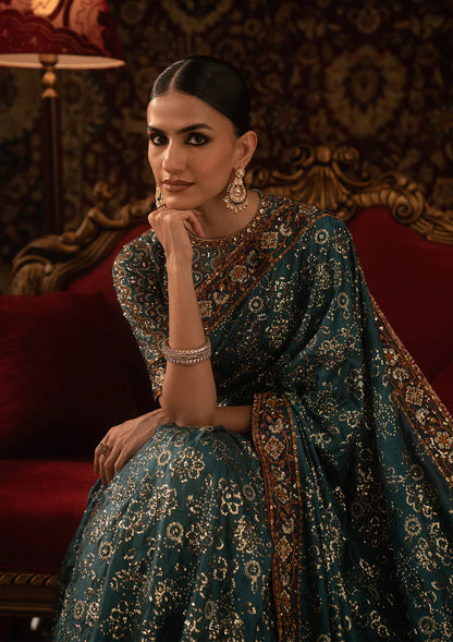 Aik Sari Edit ’25 Look 05 – Pakistani designer teal embroidered silk saree stitched with blouse & petticoat, luxury outfit at Pakistanimoda.