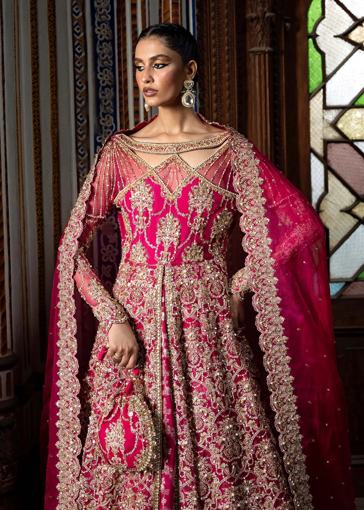 Sarosh shocking pink stitched bridal ensemble with hand-embellished pishwas, intricately designed silk lehenga, and sequin-dabka organza dupatta – formal wear for Pakistani women abroad.

