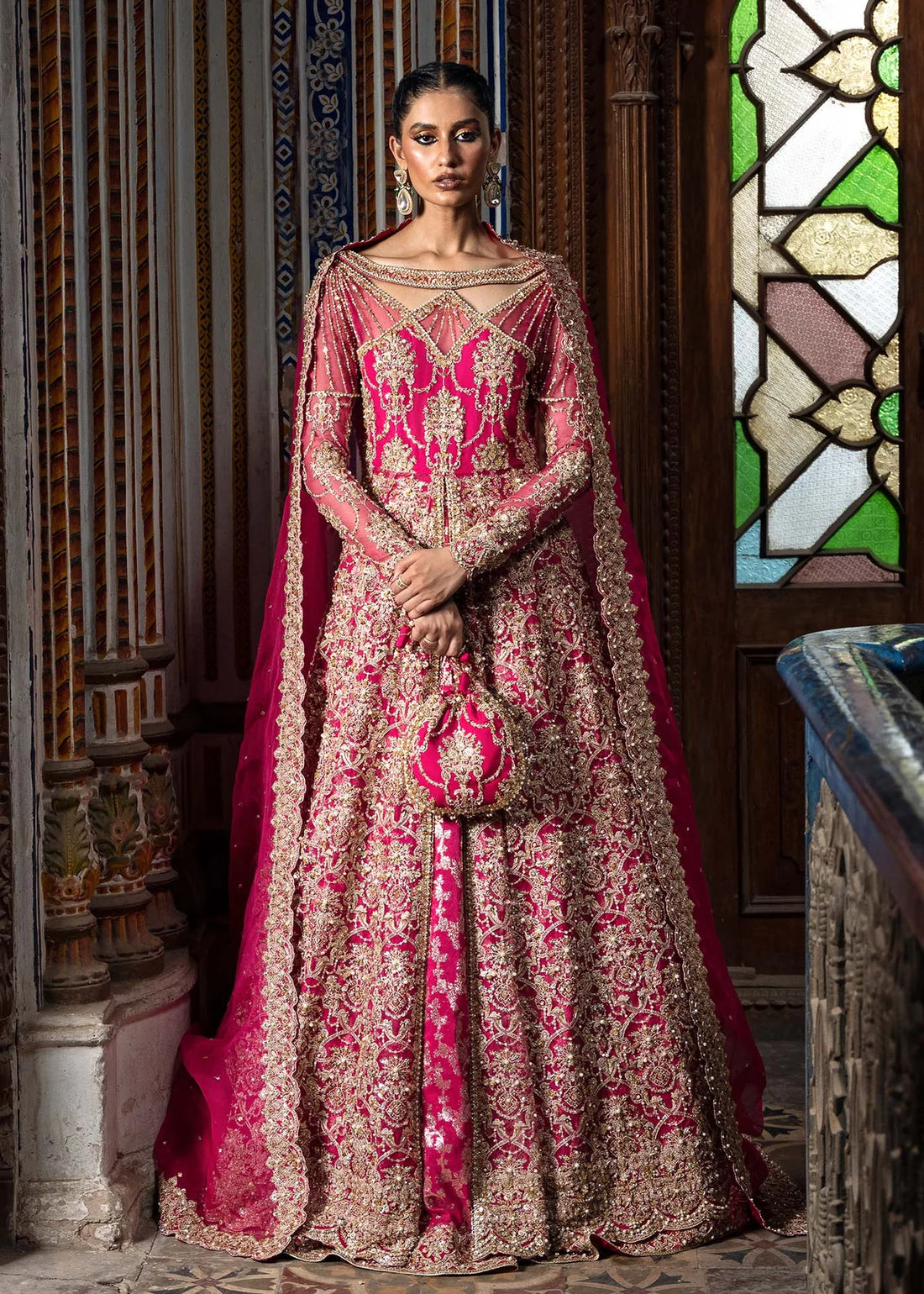 Sarosh shocking pink stitched bridal ensemble with hand-embellished pishwas, intricately designed silk lehenga, and sequin-dabka organza dupatta – formal wear for Pakistani women abroad.

