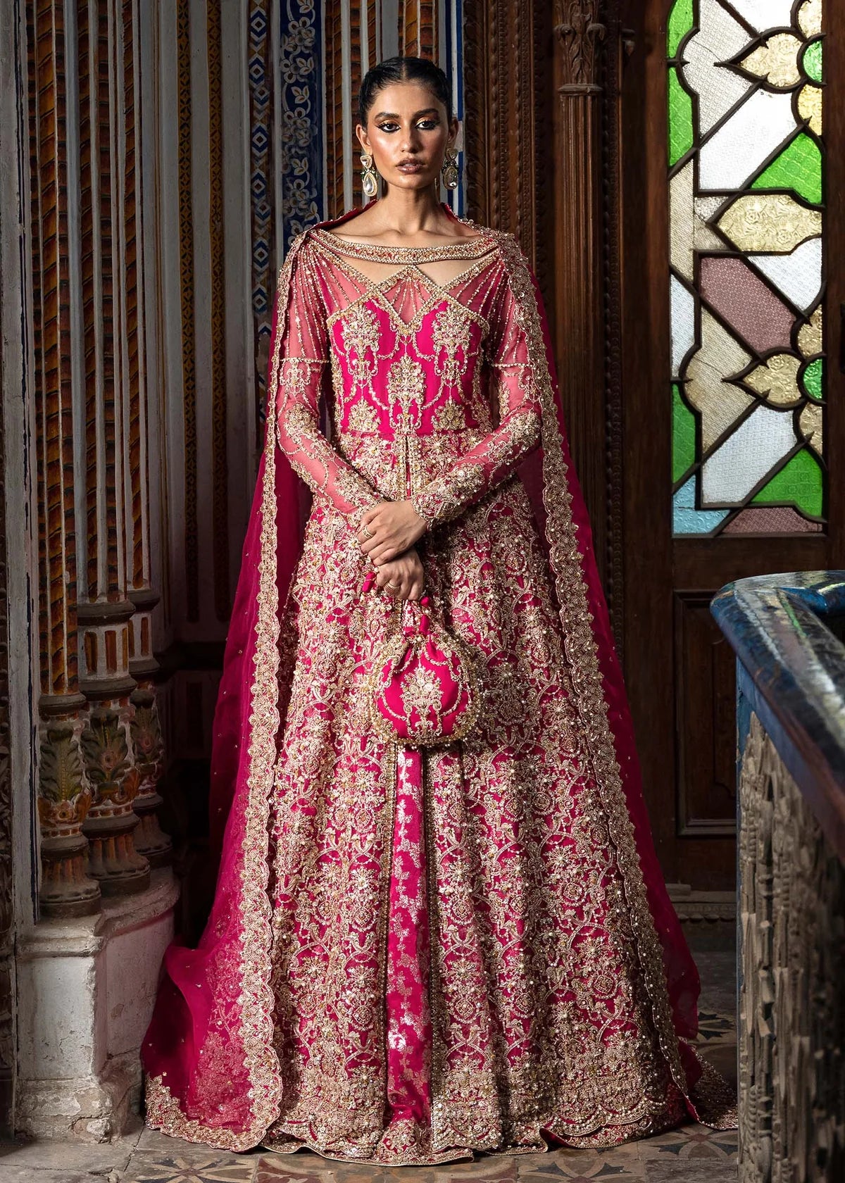 Sarosh shocking pink stitched bridal ensemble with hand-embellished pishwas, intricately designed silk lehenga, and sequin-dabka organza dupatta – formal wear for Pakistani women abroad.

