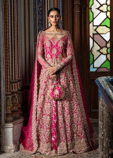 Sarosh shocking pink stitched bridal ensemble with hand-embellished pishwas, intricately designed silk lehenga, and sequin-dabka organza dupatta – formal wear for Pakistani women abroad.

