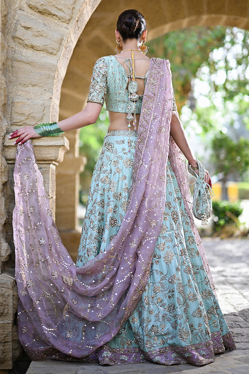 Dual-toned Pakistani bridal set in mauve and teal raw silk with Indian sleeves, gold pitta work, and mauve kamdani dupatta – perfect for brides in USA, UK, and Canada.