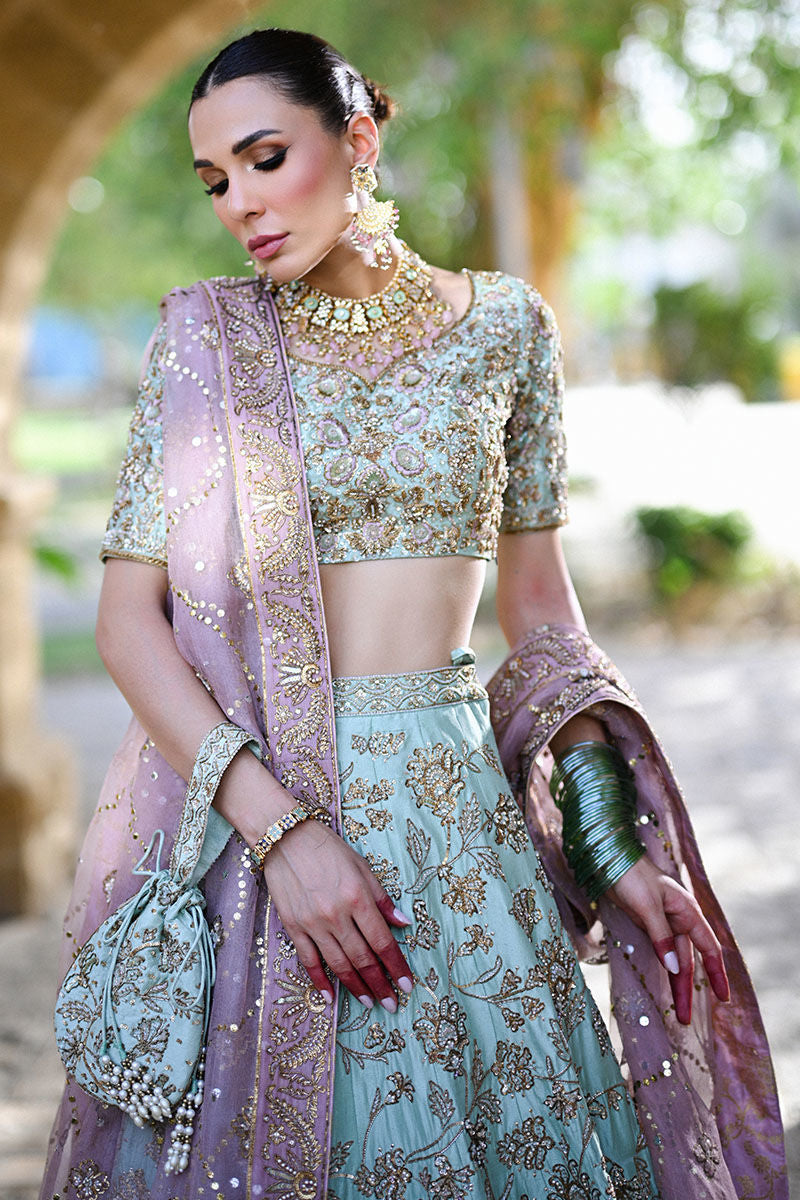 Dual-toned Pakistani bridal set in mauve and teal raw silk with Indian sleeves, gold pitta work, and mauve kamdani dupatta – perfect for brides in USA, UK, and Canada.