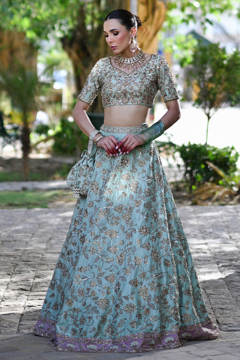 Dual-toned Pakistani bridal set in mauve and teal raw silk with Indian sleeves, gold pitta work, and mauve kamdani dupatta – perfect for brides in USA, UK, and Canada.