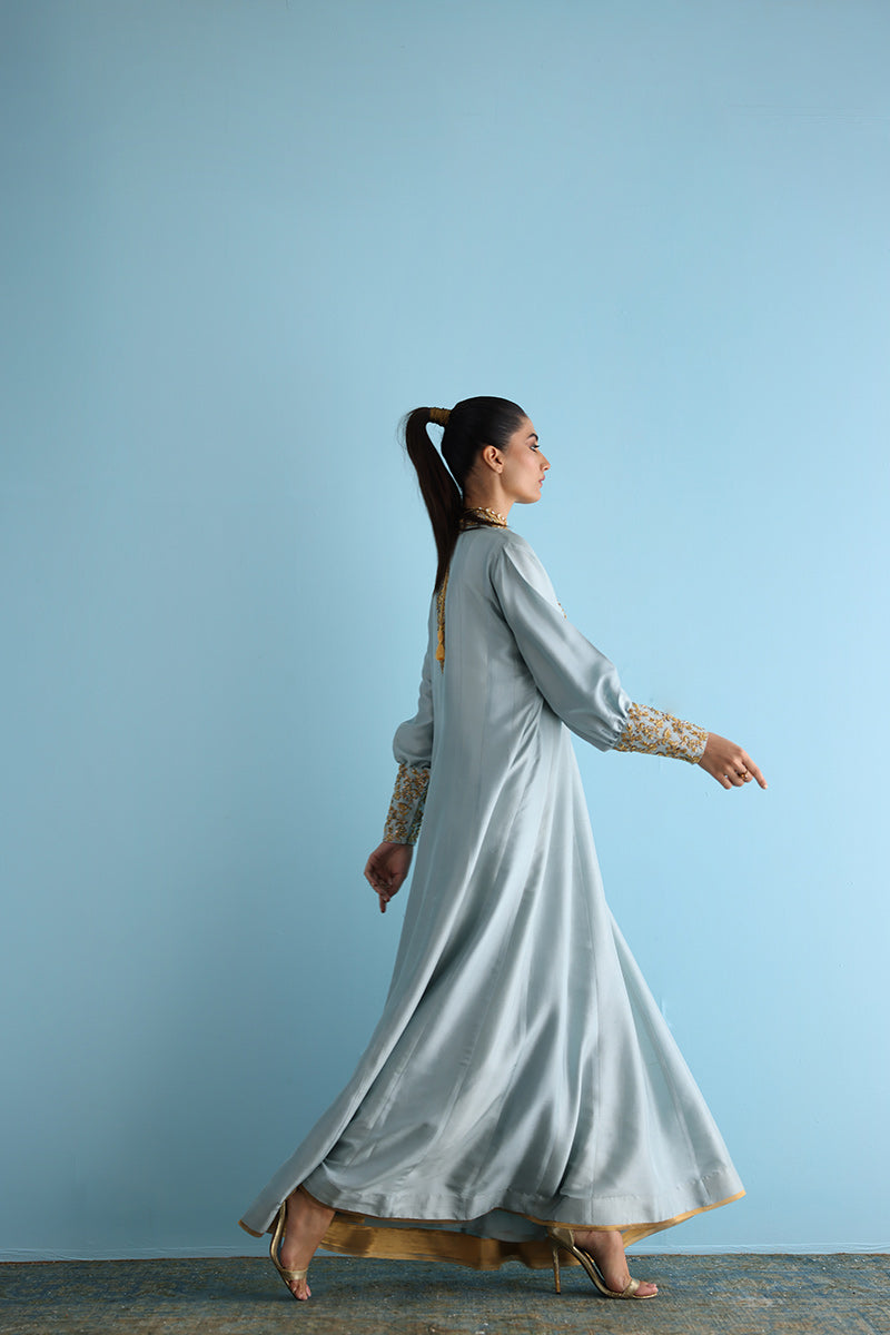 Sky blue silk high-neck dress with flared sleeves and matching pants.