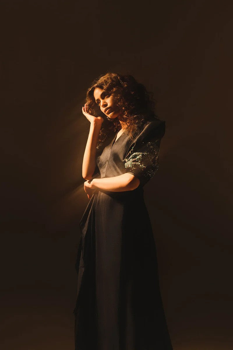 Midnight blue drape dress with crystal embellished sleeves and silk pants.