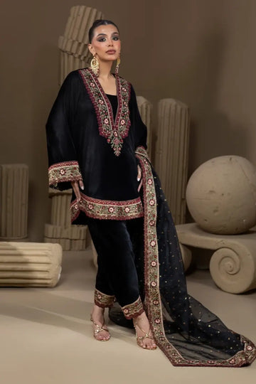 Shab-e-Gulposh jet black zardozi embroidered velvet stitched suit with maroon and gold detailing, matching velvet shalwar and organza dupatta.