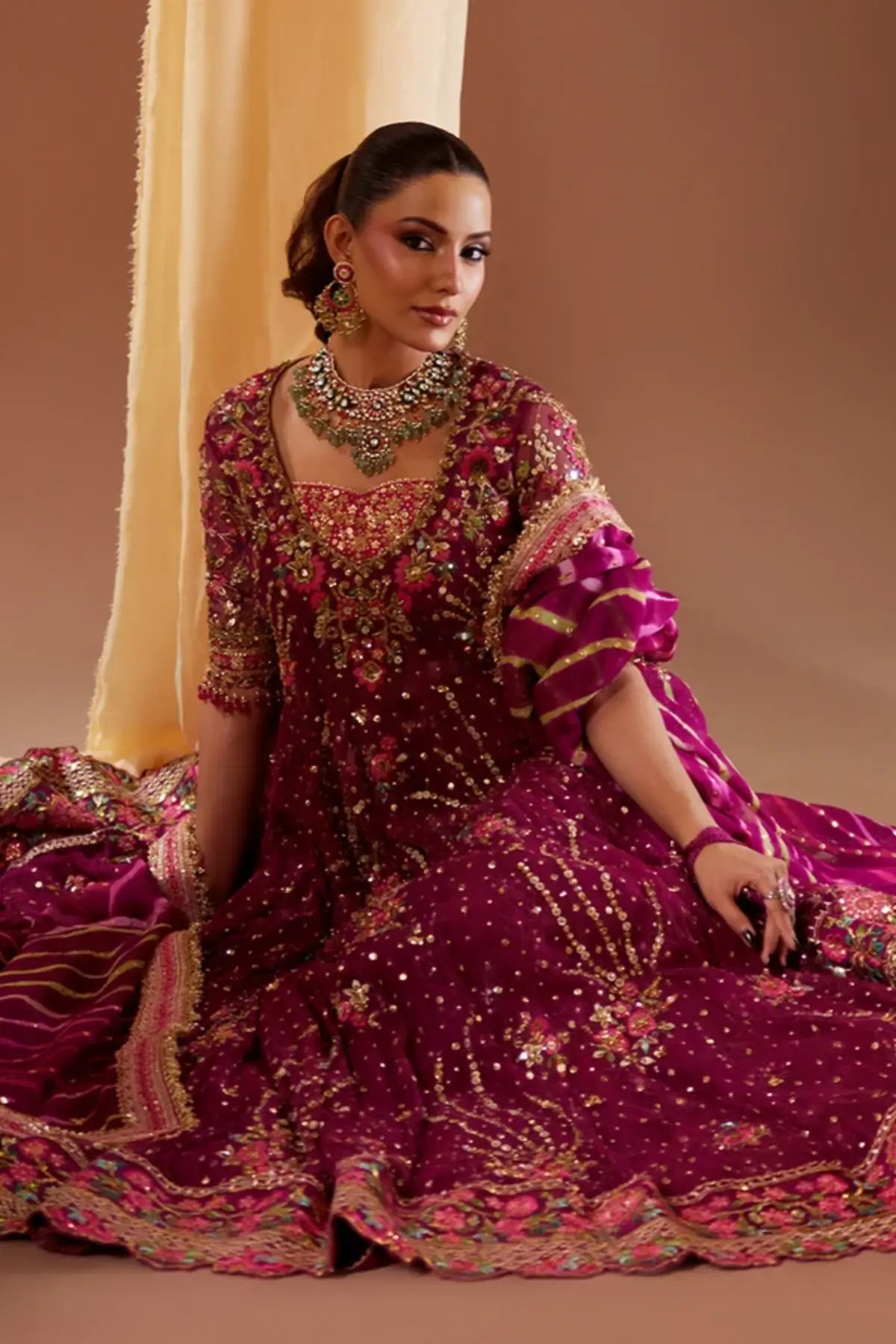 Shazdeh Deep Magenta Net Pakistani Wedding Pishwas with Gold Multicolor Embroidery, Cotton Jamawar Dhaka Pants, Striped Chiffon Dupatta and Embellished Pouch
