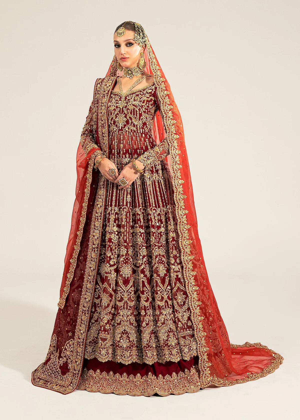 Shirin red stitched bridal pishwas and lehenga by Kanwal Malik with hand embellishments, paired with dual organza dupattas for wedding and festive events.