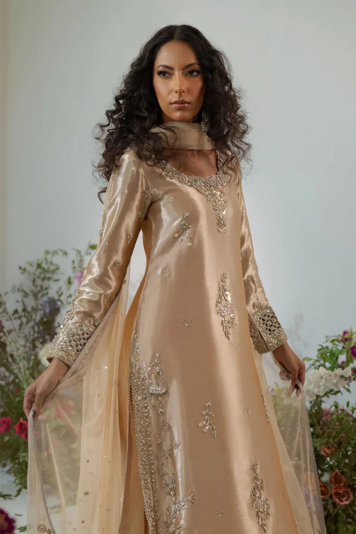 Champagne lamé A-line suit with zardozi and pearl embellishment styled for wedding guest formal wear