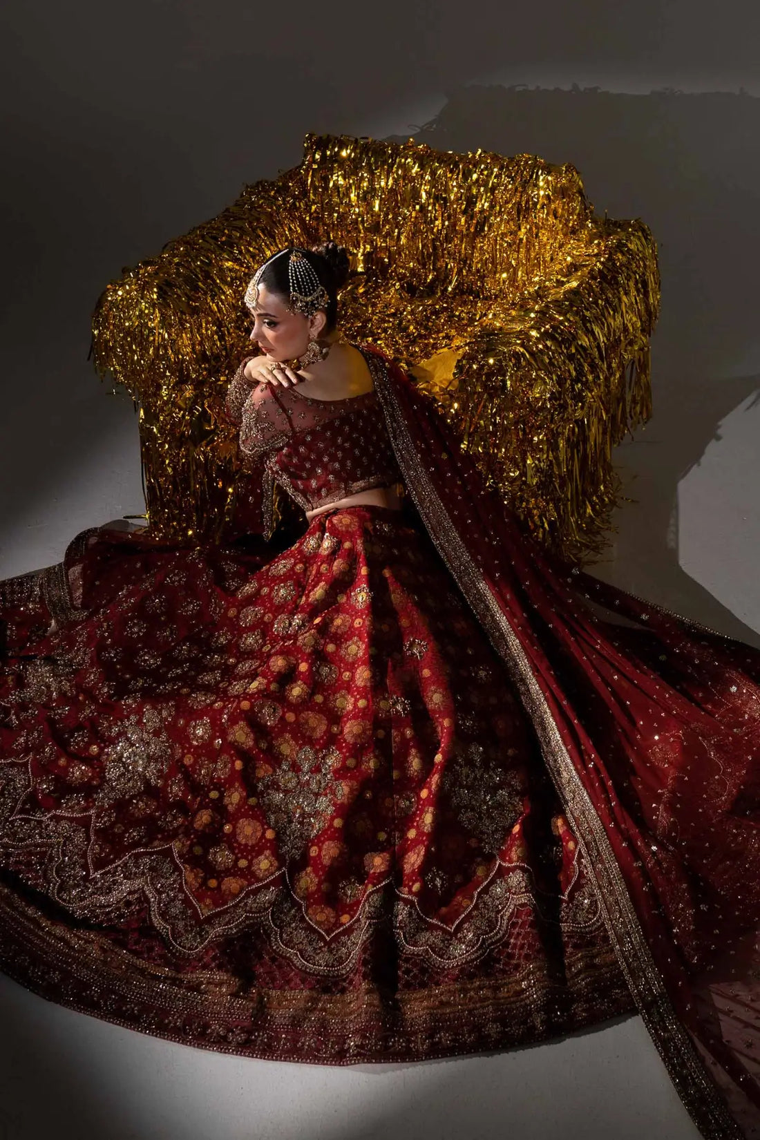 Sorrel deep red Mughal inspired bridal lehenga with jamawar skirt and net dupatta by Maria B