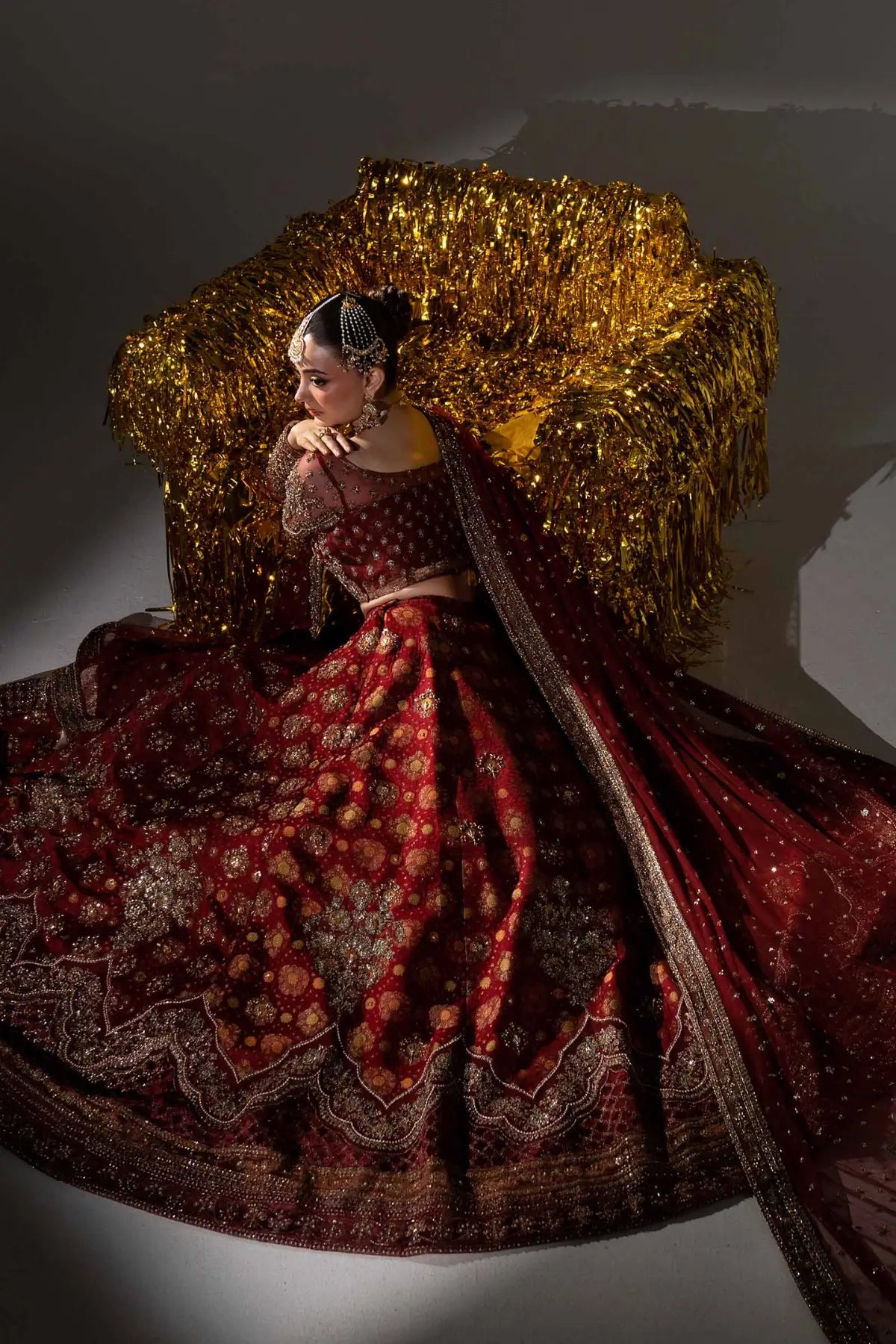 Sorrel deep red Mughal inspired bridal lehenga with jamawar skirt and net dupatta by Maria B