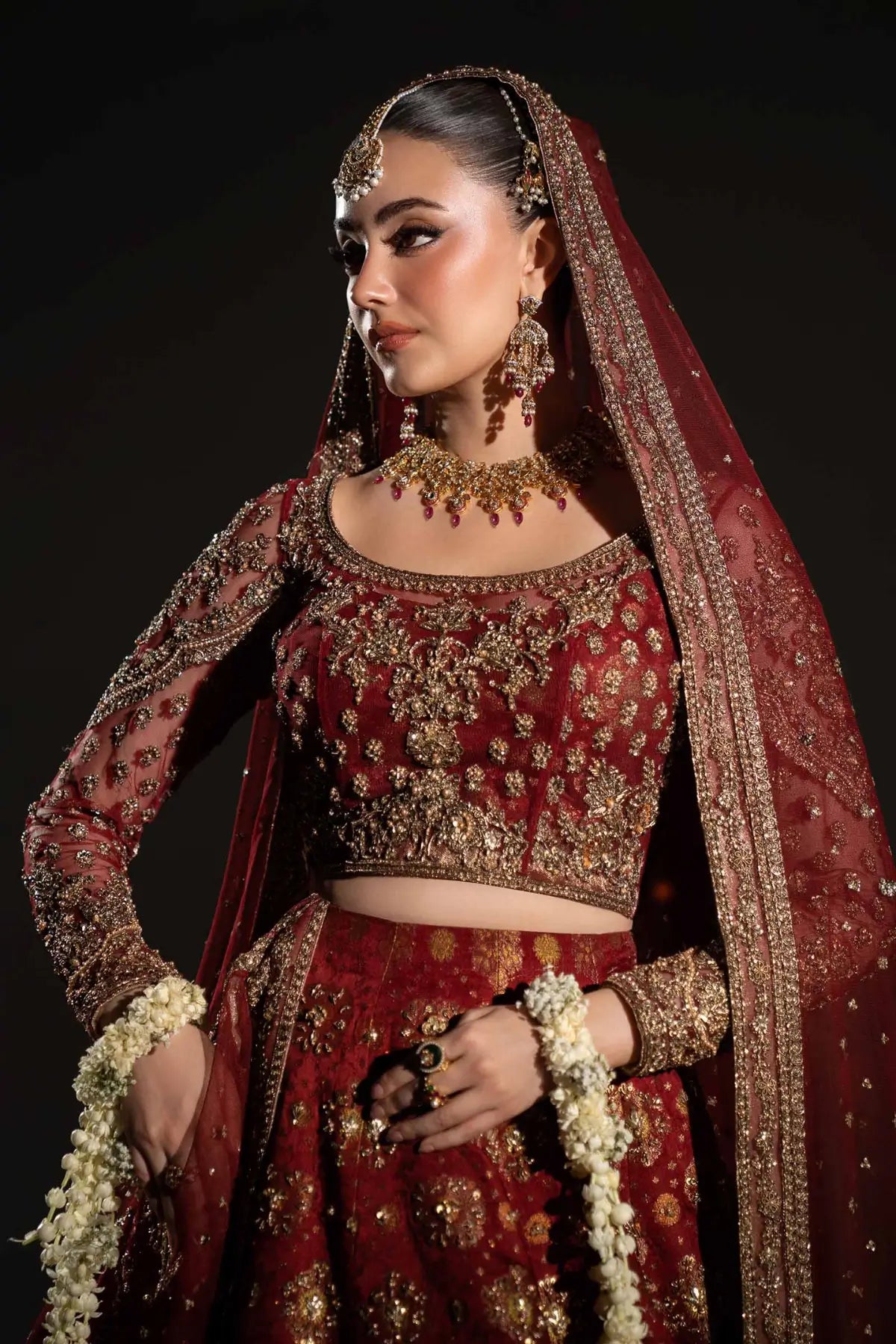 Sorrel deep red Mughal inspired bridal lehenga with jamawar skirt and net dupatta by Maria B
