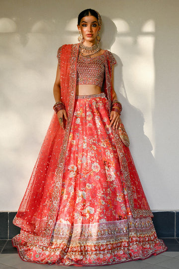Vibrant watermelon pink Pakistani bridal lehenga with raw silk choli and ombré net dupatta featuring Swarovski accents – ideal for modern brides.