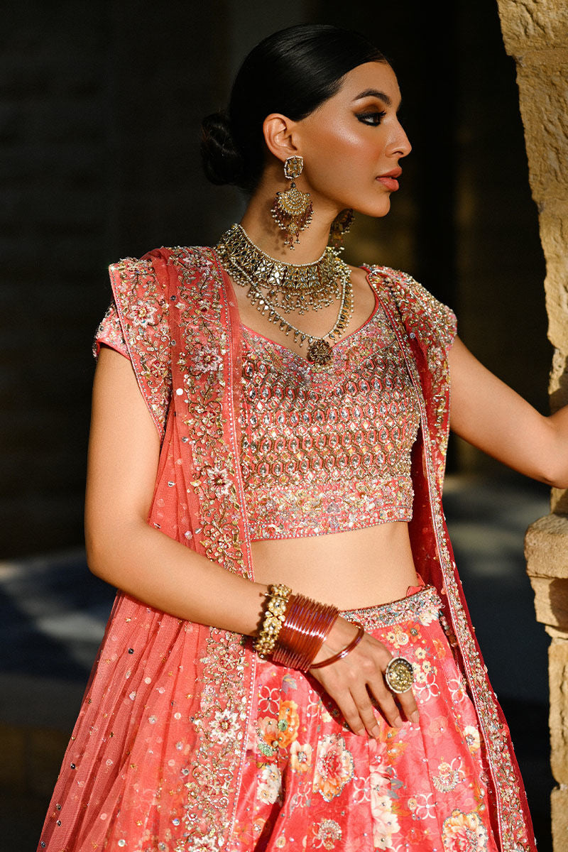 Vibrant watermelon pink Pakistani bridal lehenga with raw silk choli and ombré net dupatta featuring Swarovski accents – ideal for modern brides.