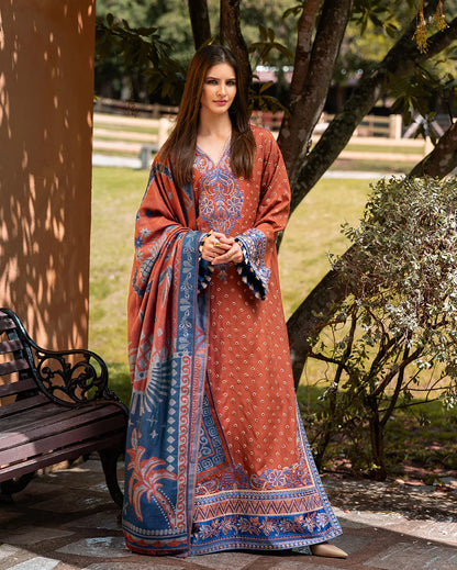 Model wearing Mushq Whispers of Change orange embroidered cottel winter outfit with wool shawl – Winter Broadway 2025