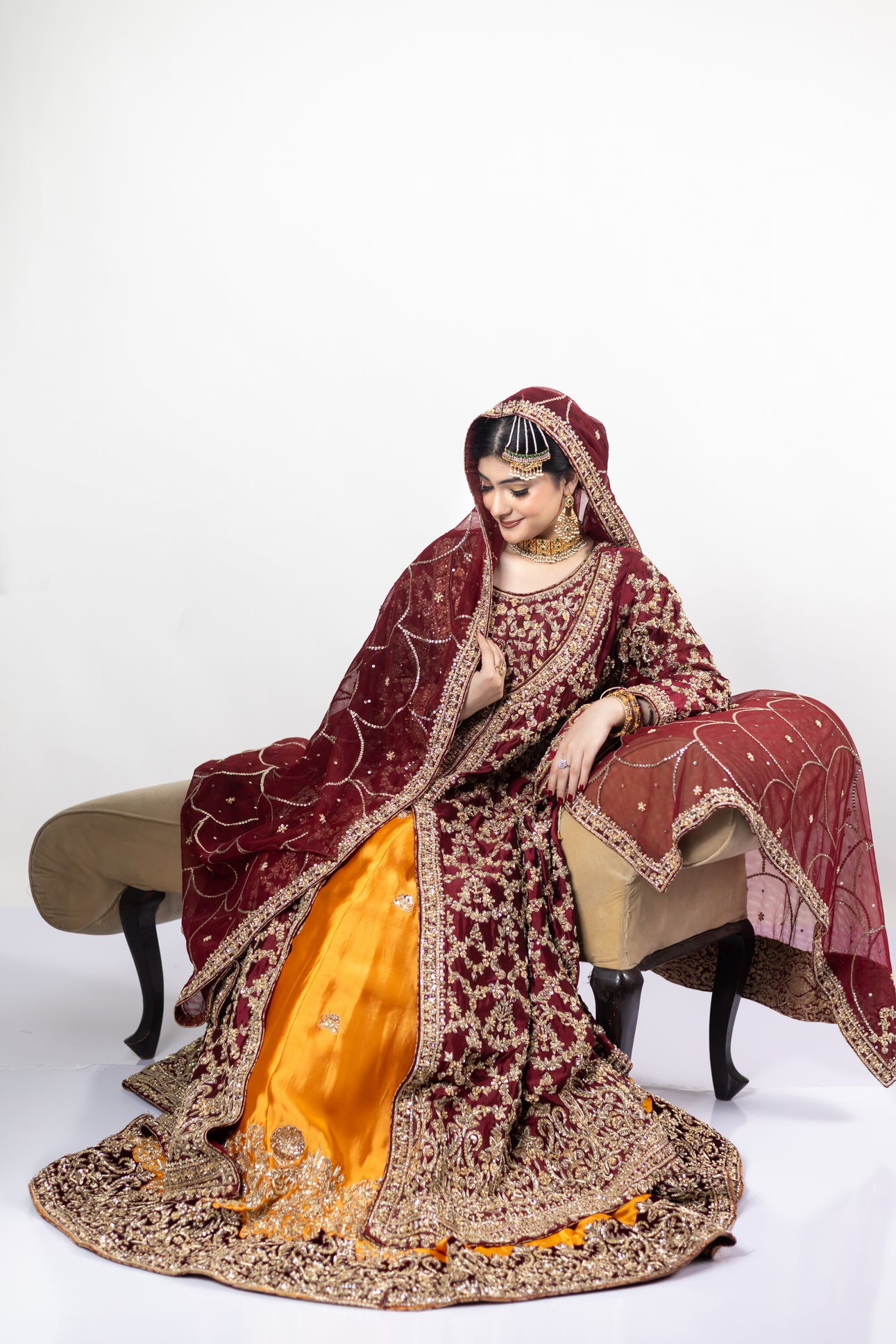 Yumna bridal ensemble by MariamRaj: Maroon raw silk front-open shirt, rust farshi lehnga, net organza dupatta, intricate embroidery for weddings and receptions