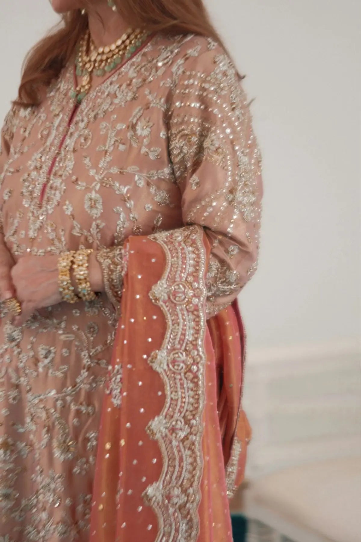 Zahia rose gold stitched formal dress for wedding guests at Pakistanimoda with hand embellishment, lame silk shirt and worked izaar