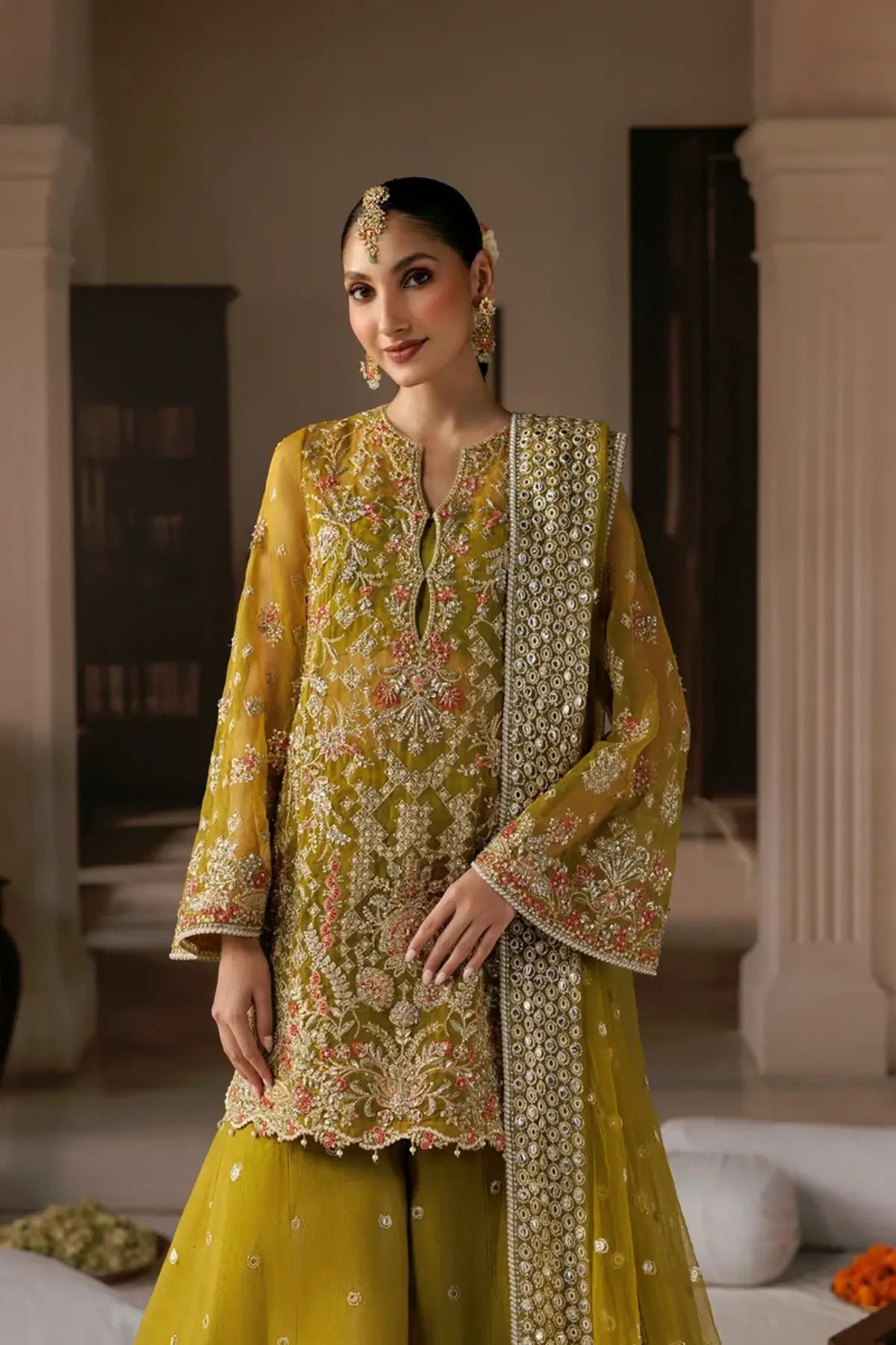 Zarminay dark yellow embroidered organza stitched Mehndi dress with floral detailing, raw silk trouser and embellished poly net dupatta