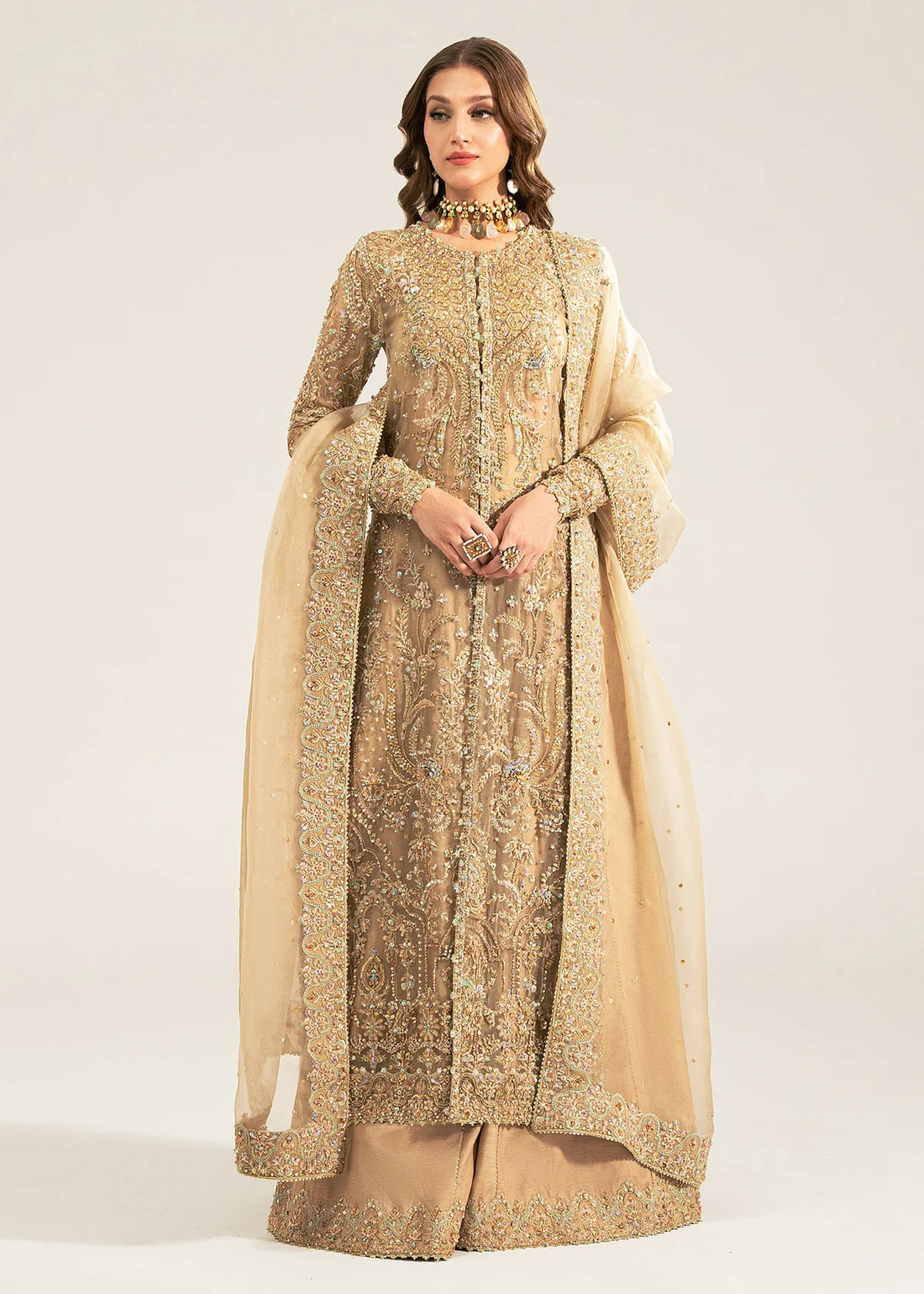 Zarnab nude stitched 4-piece outfit by Kanwal Malik with embellished open gown shirt, bustier, sharara, and organza dupatta for formal occasions.