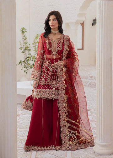 Red Pakistani flared pant suit with embroidered shirt, crystal embellishments, and printed foil dupatta – ideal for weddings and Eid events abroad.