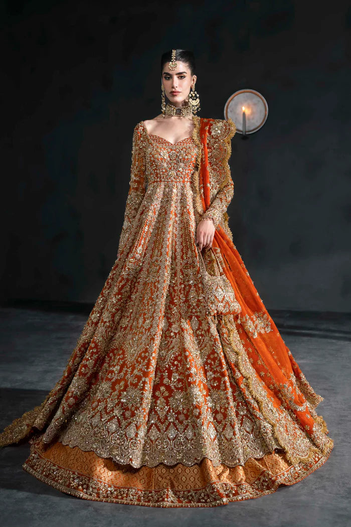 Orange bridal lehenga with gold embroidery, full sleeves, and scalloped dupatta – perfect for South Asian weddings abroad.