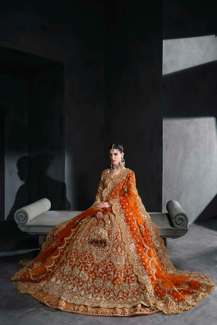 Orange bridal lehenga with gold embroidery, full sleeves, and scalloped dupatta – perfect for South Asian weddings abroad.