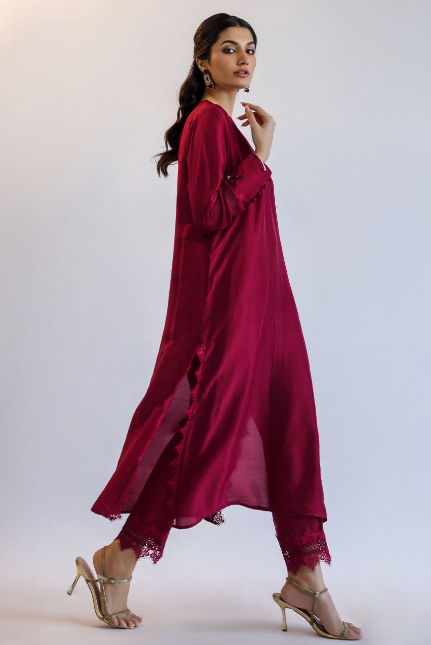 Maroon raw silk Pakistani party dress with 3D floral embroidery, katdana work, and lace finishing – custom stitched for weddings and formal events.