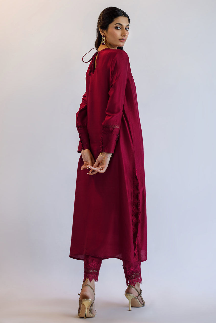 Maroon raw silk Pakistani party dress with 3D floral embroidery, katdana work, and lace finishing – custom stitched for weddings and formal events.
