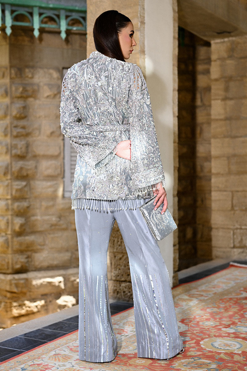 legant ice blue Pakistani formal wear featuring a hand-embellished open-front lama jacket with cutwork sleeves and waist belt, paired with embroidered raw silk flared pants – perfect for weddings and receptions in USA, UK, and Canada.